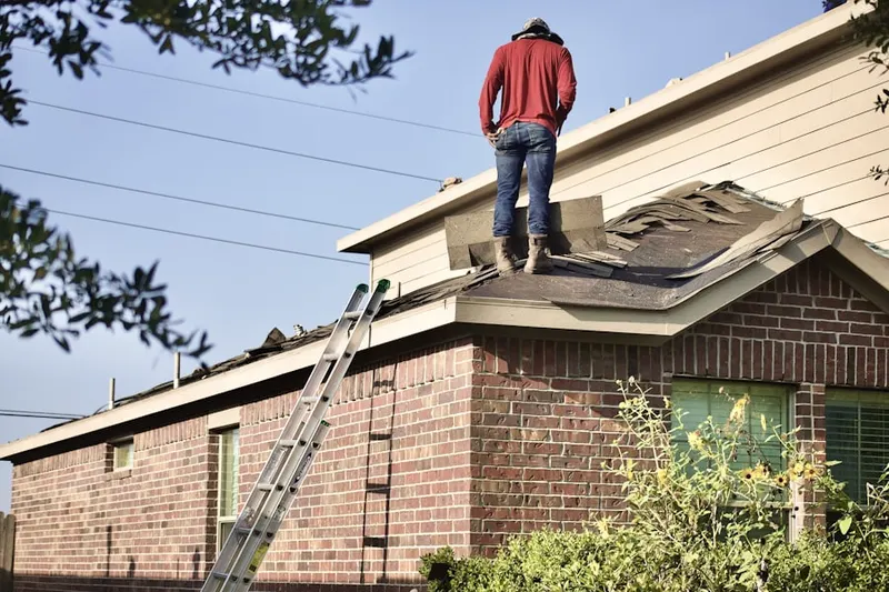 Professional roofer working on a residential roof in Harwich Port
